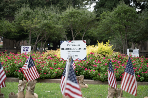 A sign for the Veteran Services office at TCU stands at the Veteran Memorial Plaza.